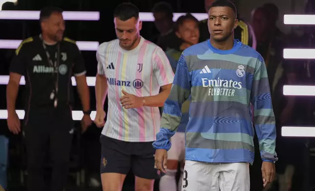 Real Madrid's Kylian Mbappe walks out to the pitch before the Club World Cup round of 16 soccer match between Real Madrid and Juventus in Miami Gardens, Fla., Tuesday, July 1, 2025. (AP Photo/Rebecca Blackwell)