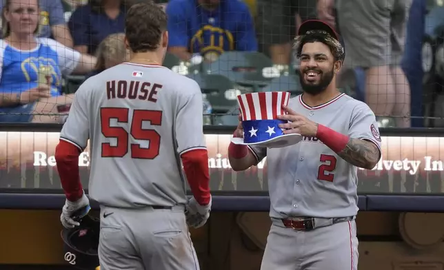 Washington Nationals' Brady House (55) is congratulated by Luis García Jr. (2) after hitting a two-run home run during the eighth inning of a baseball game against the Milwaukee Brewers, Saturday, July 12, 2025, in Milwaukee. (AP Photo/Aaron Gash)
