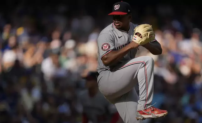 Washington Nationals' Jose A. Ferrer winds up to deliver during the eighth inning of a baseball game against the Milwaukee Brewers, Saturday, July 12, 2025, in Milwaukee. (AP Photo/Aaron Gash)