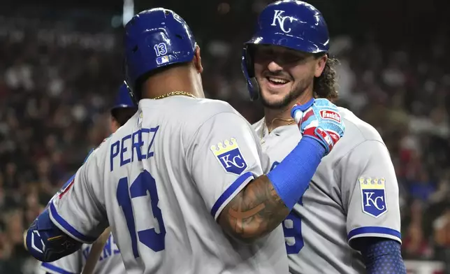 Kansas City Royals' Vinnie Pasquantino, right, celebrates with Salvador Perez (13) after hitting a two-run home run against the Arizona Diamondbacks in the fourth inning during a baseball game, Friday, July 4, 2025, in Phoenix. (AP Photo/Rick Scuteri)