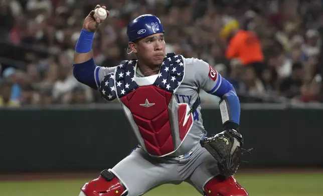 Kansas City Royals catcher Freddy Fermin makes the play for an out on a bunt-attempt by Arizona Diamondbacks Lourdes Gurriel Jr. in the first inning during a baseball game, Friday, July 4, 2025, in Phoenix. (AP Photo/Rick Scuteri)