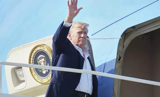 President Donald Trump waves as he boards Air Force One, Tuesday, July 29, 2025, at Royal Air Force Lossiemouth en route to return to Washington. (AP Photo/Jacquelyn Martin)