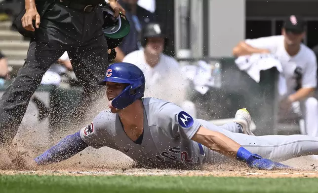 Chicago Cubs' Nico Hoerner scores during the sixth inning of a baseball game against the Chicago White Sox, Sunday, July, 27, 2025, in Chicago. (AP Photo/Matt Marton)