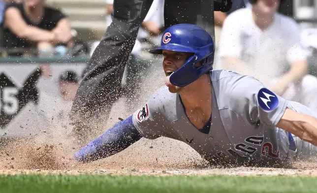 Chicago Cubs' Nico Hoerner scores during the sixth inning of a baseball game against the Chicago White Sox, Sunday, July, 27, 2025, in Chicago. (AP Photo/Matt Marton)