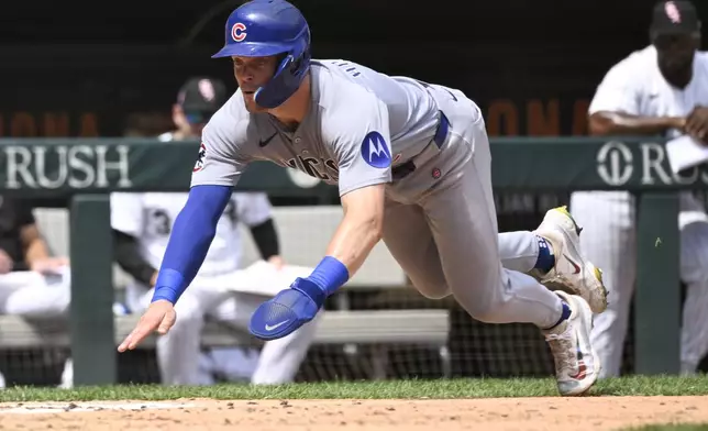 Chicago Cubs' Nico Hoerner scores during the sixth inning of a baseball game against the Chicago White Sox, Sunday, July, 27, 2025, in Chicago. (AP Photo/Matt Marton)