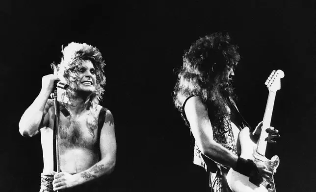 FILE - Ozzy Osbourne, left, performs, Jan. 17, 1985, at the Rock in Rio music festival in Rio de Janeiro, Brazil. (AP Photo, File)