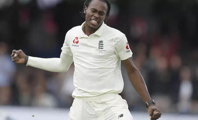 FILE - England's Jofra Archer celebrates after taking the wicket of Australia's David Warner caught by England's Rory Burns during play on day five of the 2nd Ashes Test cricket match between England and Australia at Lord's cricket ground in London, Sunday, Aug. 18, 2019. (AP Photo/Alastair Grant, File)