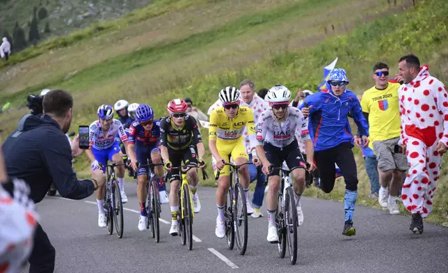 Britain's Adam Yates, Slovenia's Tadej Pogacar, wearing the overall leader's yellow jersey, Denmark's Jonas Vingegaard, Britain's Oscar Onley, and Slovenia's Primoz Roglic, climb during the eighteenth stage of the Tour de France cycling race over 171.5 kilometers (106.6 miles) with start in Vif and finish in Courchevel Col de la Loze, France, Thursday, July 24, 2025. (Bernard Papon/Pool Photo via AP)
