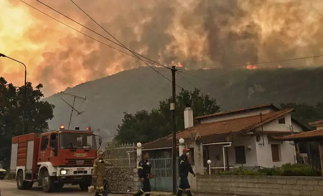 A major forest fire burns in the village of Karteri, near Corinth, west of Athens, Greece, on Tuesday, July 22, 2025. (AP Photo/Vasilis Psomas)