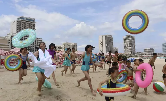 Children run into sea at the Wonsan-Kalma resort in Wonsan, Kangwon Province, North Korea, Wednesday, July 2, 2025. (AP Photo/Jon Chol Jin)