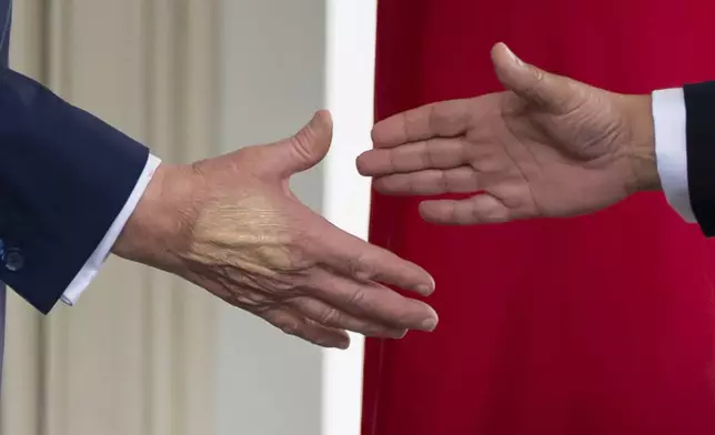 FILE - President Donald Trump, left, reaches to shake hands with Bahrain's Crown Prince Salman bin Hamad Al Khalifa speak upon his arrival at the White House, July 16, 2025, in Washington. (AP Photo/Alex Brandon, File)
