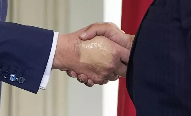 FILE - President Donald Trump, left, greets Bahrain's Crown Prince Salman bin Hamad Al Khalifa at the White House, July 16, 2025, in Washington. (AP Photo/Alex Brandon, File)