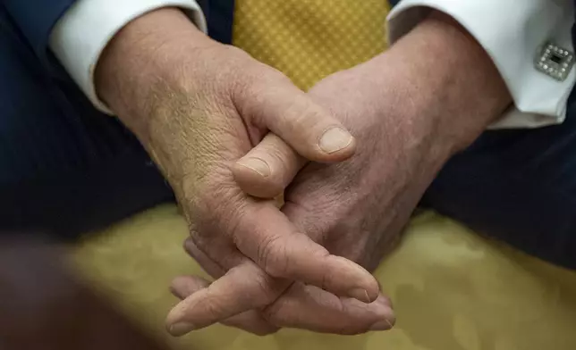 President Donald Trump sits with his hands interlocked as he and Bahrain's Crown Prince Salman bin Hamad Al Khalifa speak in the Oval Office of the White House, Wednesday, July 16, 2025, in Washington. (AP Photo/Alex Brandon)