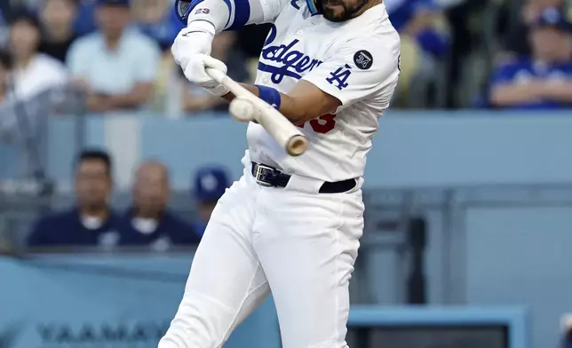 Los Angeles Dodgers' Michael Conforto hits a two-run single against the Chicago White Sox during the first inning of a baseball game Tuesday, July 1, 2025, in Los Angeles. (AP Photo/Kevork Djansezian)