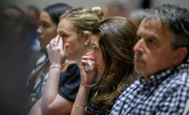 Family members of the victims of American Airlines flight 5342 who perished in a collision with a U.S. military helicopter, listen to opening statements during the NTSB fact-finding hearing on the DCA midair collision accident, at the National Transportation and Safety Board boardroom, Wednesday, July 30, 2025, in Washington. (AP Photo/Rod Lamkey, Jr.)
