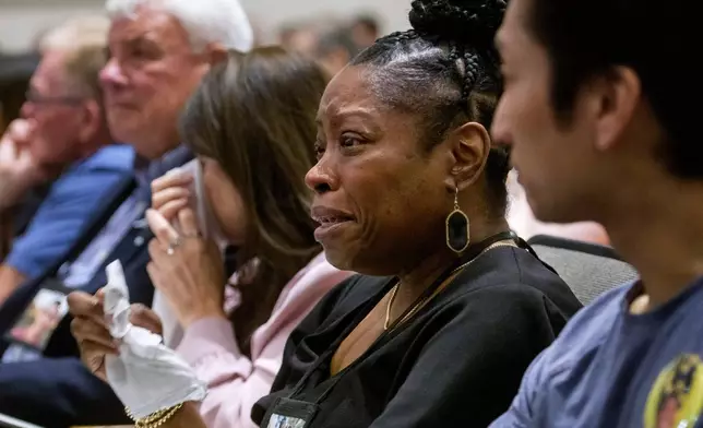 Gwen Duggins, second from right, whose daughter Kiah Duggins perished on American Airlines flight 5342 in a collision with a U.S. military helicopter, listens to the audio of the flight radio transmissions during the NTSB fact-finding hearing on the DCA midair collision accident, at the National Transportation and Safety Board boardroom, Wednesday, July 30, 2025, in Washington. (AP Photo/Rod Lamkey, Jr.)