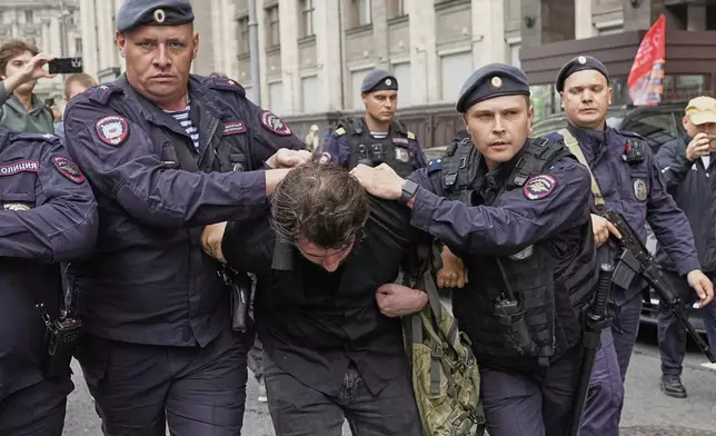 Police detain an activist in front of the State Duma, the lower house of the Russian parliament, in Moscow, Russia, Tuesday, July 22, 2025, before lawmakers approved a bill that punishes online searches for information that is deemed “extremist.” (AP Photo)