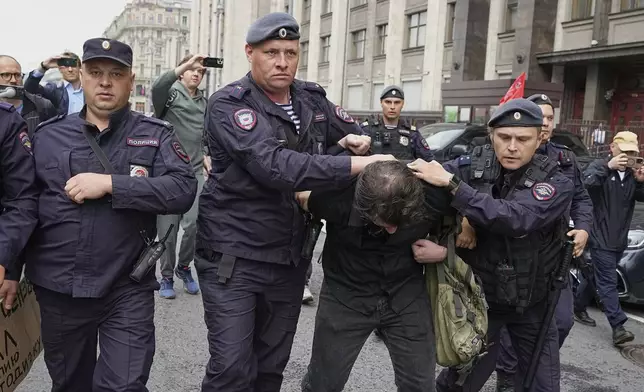 Police detain an activist during a protest in front of the State Duma, the lower house of the Russian parliament, in Moscow, Russia, Tuesday, July 22, 2025, prior to lawmakers approving a measure that punishes online searches for information that is deemed “extremist.” (AP Photo)