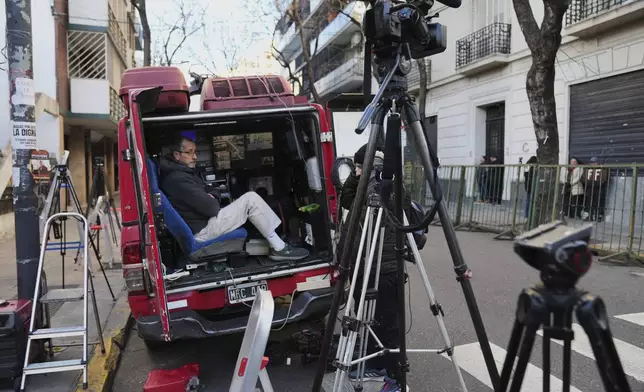 Journalists waits outside the home of former President Cristina Fernandez, who is under house arrest serving a six-year prison sentence for corruption, for the arrival of Brazil's President Luiz Inacio Lula da Silva in Buenos Aires, Argentina, Thursday, July 3, 2025. (AP Photo/Rodrigo Abd)