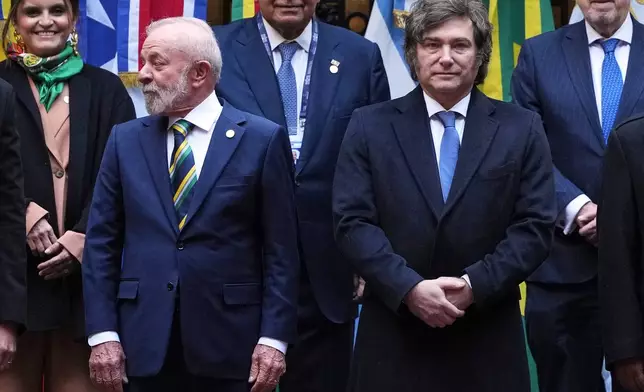 Brazil's President Luiz Inacio Lula da Silva, left, and Argentina's President Javier Milei pose for a group photo during the Mercosur Summit in Buenos Aires, Argentina, Thursday, July 3, 2025. (AP Photo/Natacha Pisarenko)