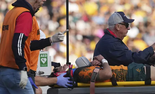 Australia's Noah Lolesio is stretched off the field after an injury during their rugby union international match against Fiji in Newcastle, Australia, Sunday, July 6, 2025. (AP Photo/Mark Baker)