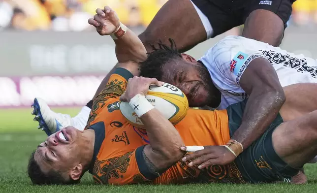 Australia's Noah Lolesio reacts as he is tackled during the rugby international between the Wallabies and Fiji in Newcastle, Australia, Sunday, July 6, 2025. (AP Photo/Mark Baker)