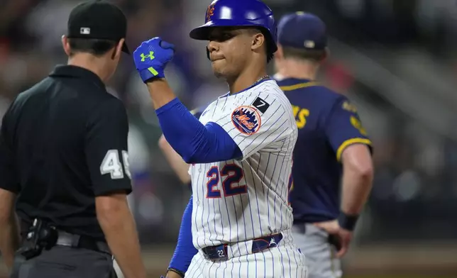 New York Mets' Juan Soto (22) gestures to teammates after hitting an RBI single during the sixth inning of a baseball game against the Milwaukee Brewers Thursday, July 3, 2025, in New York. (AP Photo/Frank Franklin II)