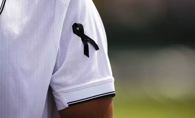 Francisco Cabral of Portugal, wearing a black ribbon in memory of compatriot and soccer player Diogo Jota, on day five of the Wimbledon Championships in, London, Friday July 4, 2025. (Mike Egerton/PA via AP)
