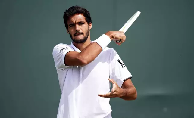 Francisco Cabral of Portugal, wearing a black ribbon in memory of compatriot and soccer player Diogo Jota, on day five of the Wimbledon Championships in, London, Friday July 4, 2025. (Mike Egerton/PA via AP)