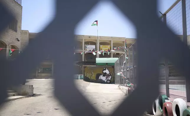Memorial banners for Palestinian-American Sayfollah Musallet and Mohammed al-Shalabi, both killed by Israeli settlers, are displayed at a school in the West Bank town of Al Mazra as-Sharqiya, Monday, July 21, 2025. (AP Photo/Maya Alleruzzo)