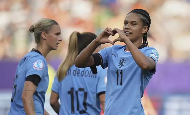 Netherlands' Esmee Brugts, right, celebrates after scoring her side's third goal during the Euro 2025, group D, soccer match between Wales and the Netherlands at Allmend Stadion Luzern in Lucerne, Switzerland, Saturday, July 5, 2025. (AP Photo/Alessandra Tarantino)