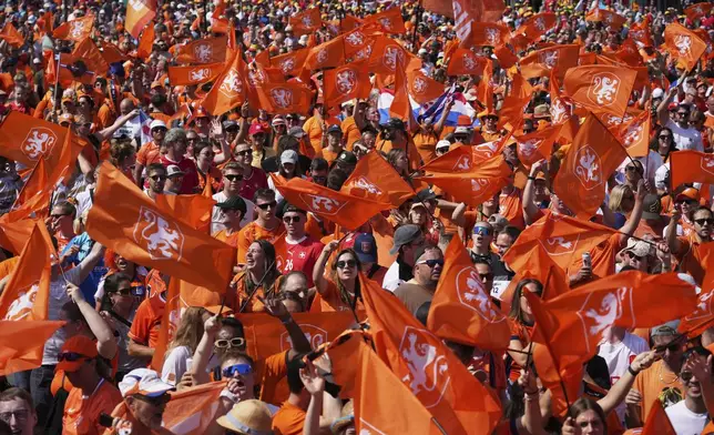 Netherlands supporters head to the stadium for the Euro 2025, group D, soccer match between Wales and the Netherlands at Allmend Stadion Luzern in Lucerne, Switzerland, Saturday, July 5, 2025. (AP Photo/Alessandra Tarantino)