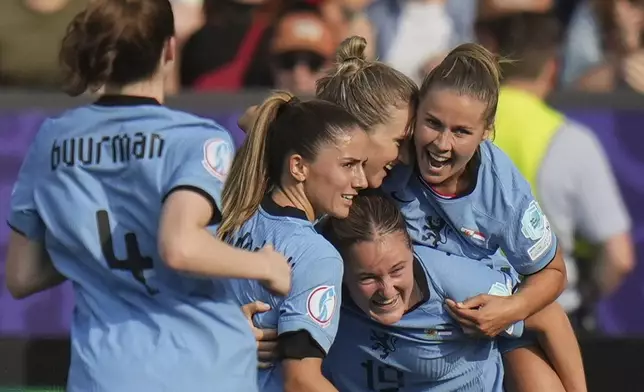 Netherlands' Vivianne Miedema, center, celebrates with her teammates after scoring his side's opening goal during the Euro 2025, group D, soccer match between Wales and the Netherlands at Allmend Stadion Luzern in Lucerne, Switzerland, Saturday, July 5, 2025. (AP Photo/Alessandra Tarantino)