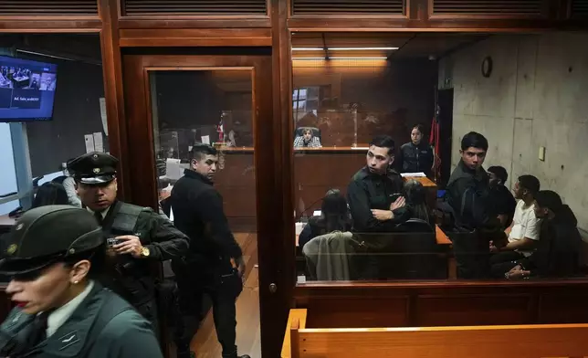 Alleged members of the Tren de Aragua gang attend a preliminary hearing facing homicide charges, in Santiago, Chile, July 9, 2025. (AP Photo/Esteban Felix)