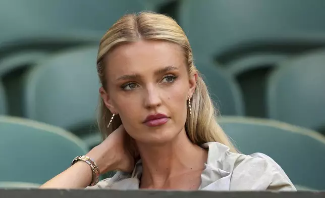 Morgan Riddle the girlfriend of Taylor Fritz of the U.S. takes her seat before her boyfriend plays Spain's Carlos Alcaraz in a men's singles semifinal at the Wimbledon Tennis Championships in London, Friday, July 11, 2025. (AP Photo/Kin Cheung)