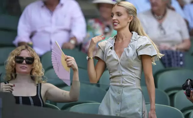 Morgan Riddle the girlfriend of Taylor Fritz of the U.S. arrives to take her seat before her boyfriend plays Spain's Carlos Alcaraz in a men's singles semifinal at the Wimbledon Tennis Championships in London, Friday, July 11, 2025. (AP Photo/Kin Cheung)