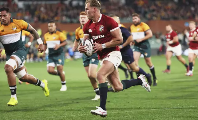 Duhan van der Merwe of the British &amp; Irish Lions runs to score a try during the rugby match between the Lions and the AUNZ Invitational XV in Adelaide, Saturday, July 12, 2025. (AP Photo/James Elsby)
