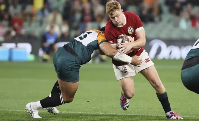 Fin Smith of the British &amp; Irish Lions is tackled by Ngani Laumape of the AUNZ Invitational XV during the rugby match between the Lions and the AUNZ Invitational XV in Adelaide, Saturday, July 12, 2025. (AP Photo/James Elsby)