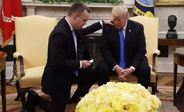 President Donald Trump prays with pastor Andrew Brunson in the Oval Office of the White House, Oct. 13, 2018, in Washington. (AP Photo/Jacquelyn Martin, File)