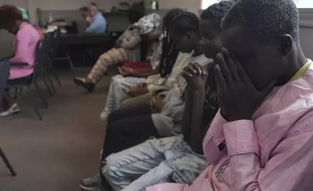 Worshippers pray during service at The Reformed Baptist Church in Saint Jerome, Quebec, Sunday, June 29, 2025. (AP Photo/Luis Andres Henao)