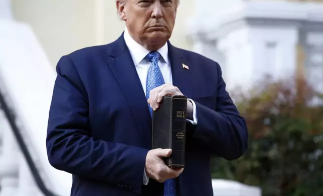FILE - President Donald Trump holds a Bible as he visits outside St. John's Church across Lafayette Park from the White House in Washington, June 1, 2020. (AP Photo/Patrick Semansky, File)