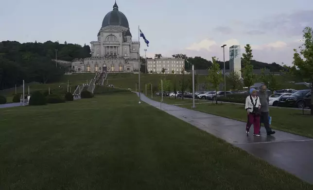 Visitors leave the national shrine of Saint Joseph's Oratory of Mount Royal in Montreal, Saturday, June 28, 2025. (AP Photo/Luis Andres Henao)
