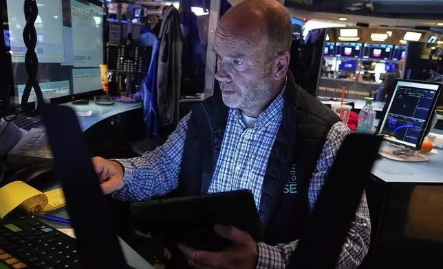 Trader Peter Mancuso works on the floor of the New York Stock Exchange, Friday, July 18, 2025. (AP Photo/Richard Drew)