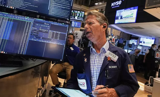 Trader Robert Charmak works on the floor of the New York Stock Exchange, Friday, July 18, 2025. (AP Photo/Richard Drew)