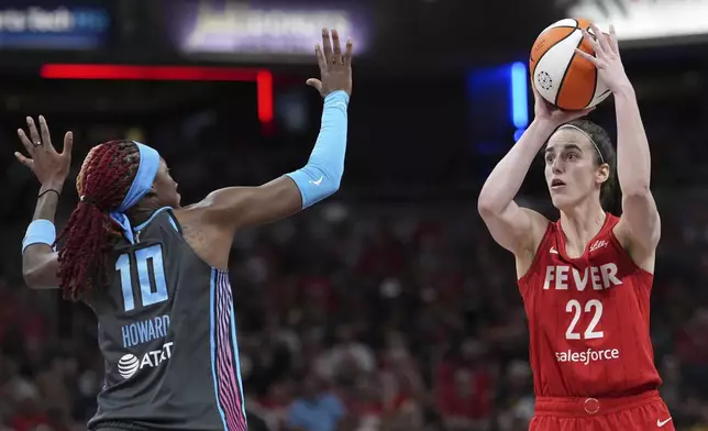 Indiana Fever's Caitlin Clark (22) shoots over Atlanta Dream's Rhyne Howard (10) during the second half of a WNBA basketball game, Friday, July 11, 2025, in Indianapolis. (AP Photo/AJ Mast)
