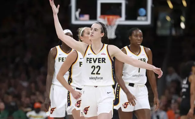 Indiana Fever's Caitlin Clark (22) gestures to the crowd during the first half of a WNBA basketball game against the Connecticut Sun Tuesday, July 15, 2025, in Boston. (AP Photo/Michael Dwyer)