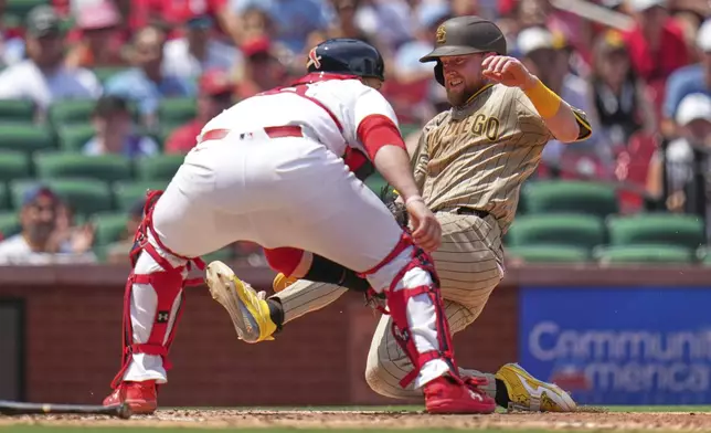San Diego Padres' Jake Cronenworth, right, scores past St. Louis Cardinals catcher Pedro Pages during the fourth inning of a baseball game Sunday, July 27, 2025, in St. Louis. (AP Photo/Jeff Roberson)