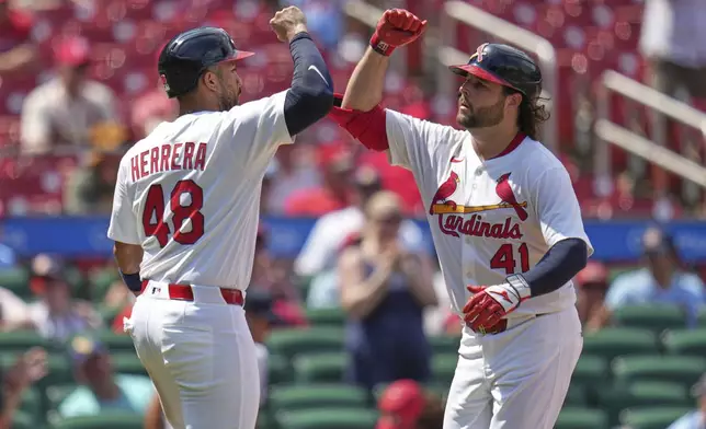 St. Louis Cardinals' Alec Burleson (41) is congratulated by teammate Ivan Herrera (48) after hitting a two-run home run during the sixth inning of a baseball game against the San Diego Padres Sunday, July 27, 2025, in St. Louis. (AP Photo/Jeff Roberson)