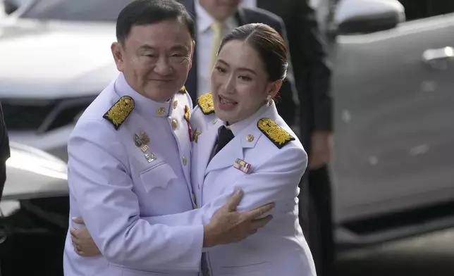 FILE - Thailand's former Prime Minister Thaksin Shinawatra, left, hugs his daughter and newly elected Prime Minister Paetongtarn Shinawatra before the royal endorsement ceremony appointing Paetongtarn as Thailand's new prime minister at Pheu Thai party headquarters in Bangkok, Thailand, on Aug. 18, 2024. (AP Photo/Sakchai Lalit, File)