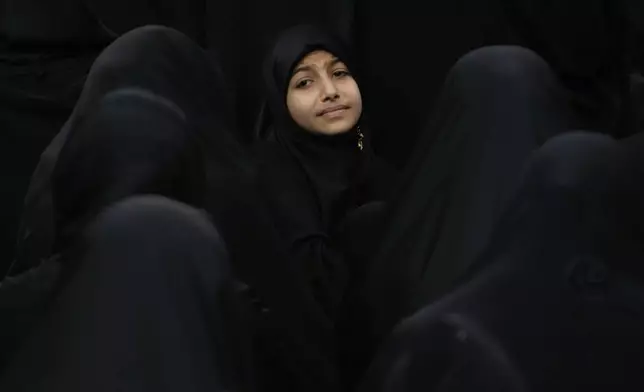 Iranian Shiite Muslims mourn in Ashoura, the holy day on which they commemorate the martyrdom of Imam Hussein, grandson of the Prophet Muhammad, who was killed in Battle of Karbala in present-day Iraq, in 680 AD, in Tehran, Iran, Sunday, July 6, 2025. (AP Photo/Vahid Salemi)